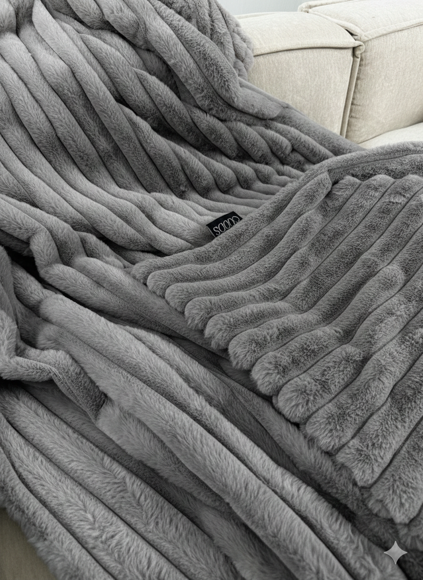 A Cudds fluffy throw on a sofa